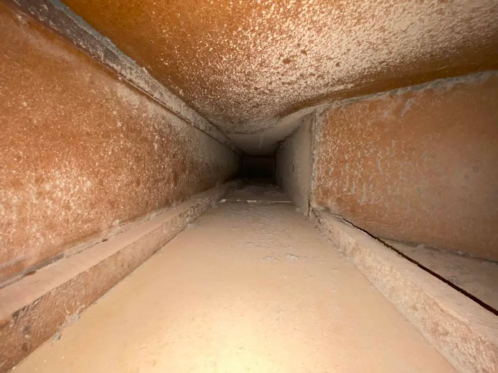 Before: duct interior loaded with dust and debris