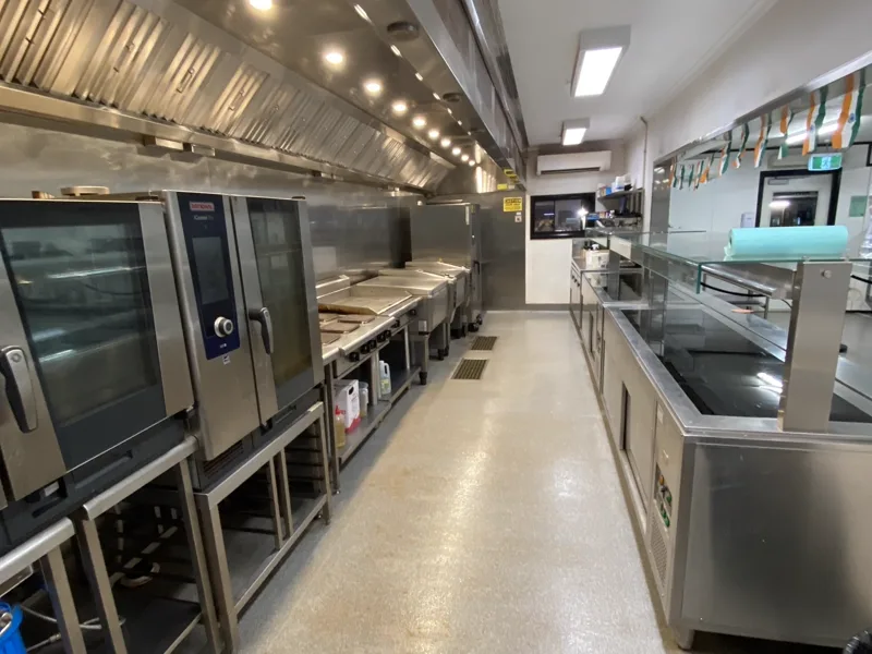 Commercial kitchen cook line clean and dry after an overnight exhaust clean